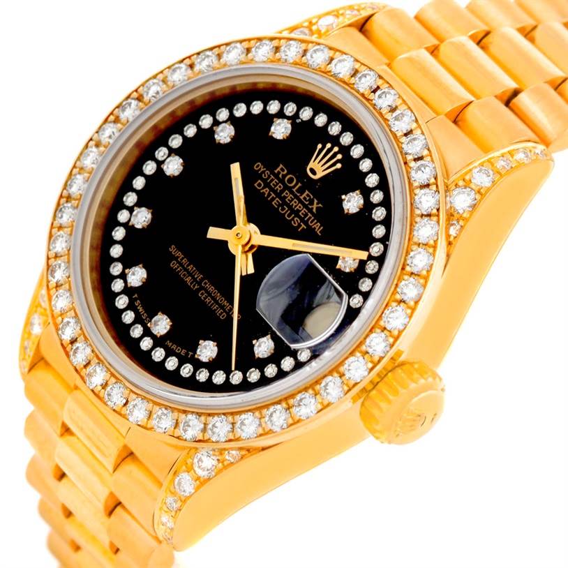 The image shows a close-up of the Rolex President 69158 Women's Yellow Gold Black Dial 69158 Women's Yellow Gold Black Dial model watch, featuring the bezel, dial, and part of the bracelet band.
