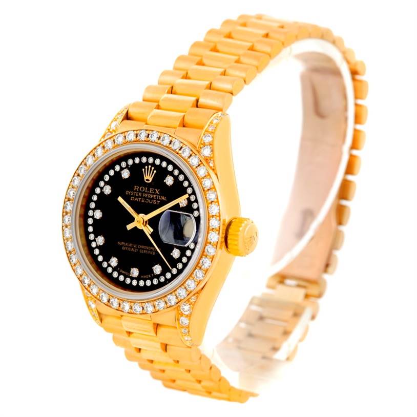 The image shows a Rolex President 69158 Women's Yellow Gold Black Dial 69158 Women's Yellow Gold Black Dial model watch from an angle highlighting its face, crown, bezel, and bracelet.