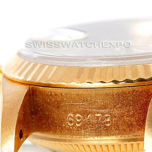 This image shows a close-up view of the case side of a Rolex President 69178 Women's Yellow Gold Champagne Dial 69178 Women's Yellow Gold Champagne Dial model watch, highlighting its serial number and bezel.