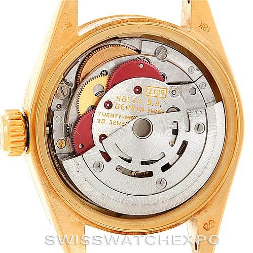 The image shows the internal mechanical movement of a Rolex President 69178 Women's Yellow Gold Champagne Dial 69178 Women's Yellow Gold Champagne Dial model watch, displaying gears and the rotor.