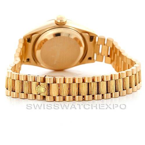 The image shows a rear view of the Rolex President 69278 Women's Yellow Gold Champagne Dial 69278 Women's Yellow Gold Champagne Dial model watch, highlighting its gold case back and bracelet.