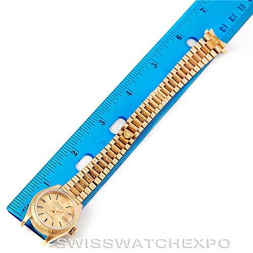 The image shows a Rolex President 69278 Women's Yellow Gold Champagne Dial 69278 Women's Yellow Gold Champagne Dial model watch lying flat against a blue ruler, displaying its bracelet and watch face.