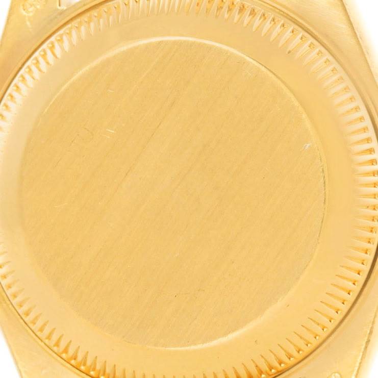 The image shows the closed case back of a Rolex President 69178 Women
s Yellow Gold Brown Dial 69178 Women
s Yellow Gold Brown Dial model watch from a top-down angle.