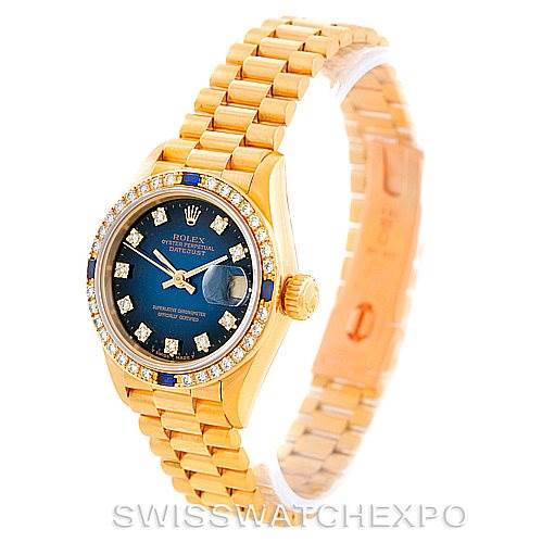 The image shows a Rolex President 69088 Women's Yellow Gold Blue Dial 69088 Women's Yellow Gold Blue Dial model watch at a slight angle, featuring its gold case, blue dial, and diamond bezel with the bracelet partially extended.