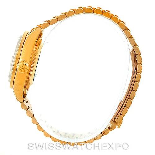 This image shows a side view of the Rolex President 69158 Women's Yellow Gold Champagne Dial 69158 Women's Yellow Gold Champagne Dial model, highlighting its crown, case, and bracelet.