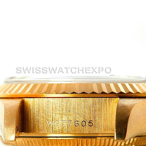 The image shows a close-up of the side of a Rolex President 69178 Women's Yellow Gold Champagne Dial 69178 Women's Yellow Gold Champagne Dial model watch, highlighting its serial number engraving on the case between the lugs.