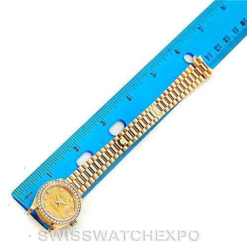 This image shows the face and bracelet of a Rolex President 69138 Women's Yellow Gold Champagne Dial 69138 Women's Yellow Gold Champagne Dial model watch, placed next to a blue ruler for scale.