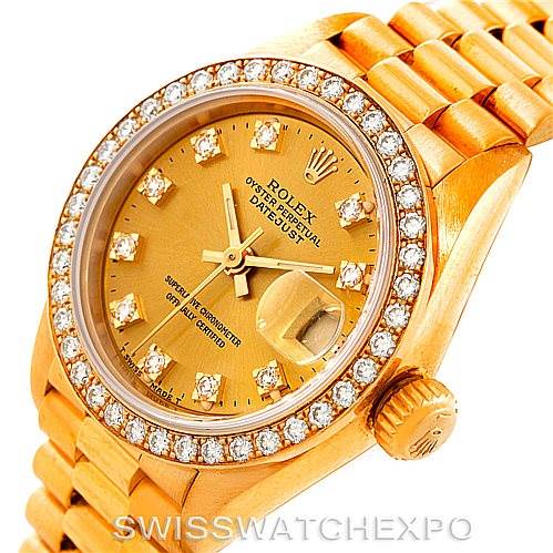 This image shows a Rolex President 69138 Women's Yellow Gold Champagne Dial 69138 Women's Yellow Gold Champagne Dial model watch from an angled view, highlighting its diamond bezel, gold dial, and crown.
