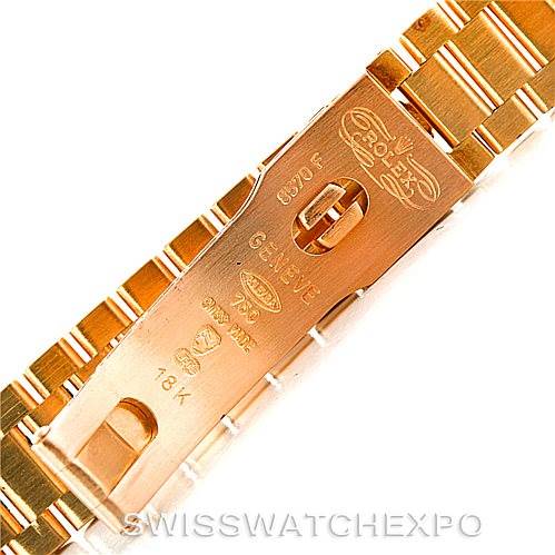 This image shows a close-up of the clasp mechanism on a Rolex President 69138 Women's Yellow Gold Champagne Dial 69138 Women's Yellow Gold Champagne Dial watch's gold bracelet.