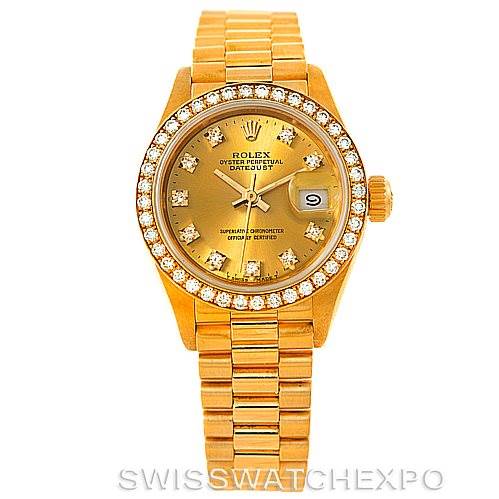 The image shows a front view of the Rolex President 69138 Women's Yellow Gold Champagne Dial 69138 Women's Yellow Gold Champagne Dial model, featuring its gold bracelet, jeweled bezel, and date window at 3 o'clock.