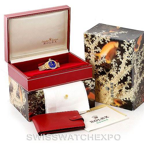 The image shows a Rolex President 79158 Women's Yellow Gold  79158 Women's Yellow Gold  model watch in its open box, with manuals, a wallet, and outer packaging displayed.