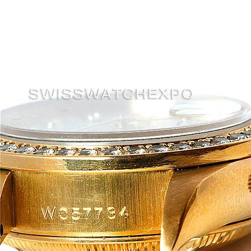 The image shows a side angle of a Rolex President 69138 Women
s Yellow Gold Beige Dial 69138 Women
s Yellow Gold Beige Dial model watch, highlighting the engraved serial number and part of the bezel.