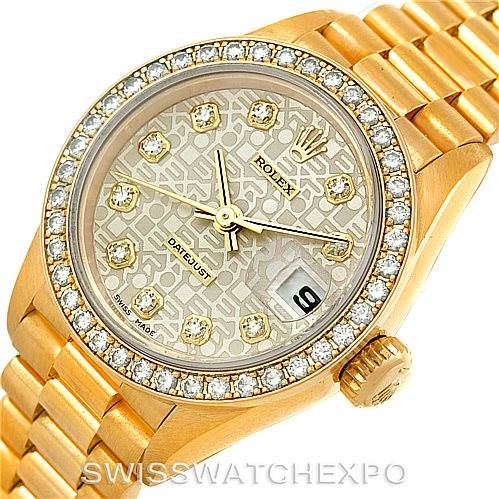 This image shows a Rolex President 69138 Women
s Yellow Gold Beige Dial 69138 Women
s Yellow Gold Beige Dial model watch from an overhead angle, featuring the dial, bezel, and part of the bracelet.