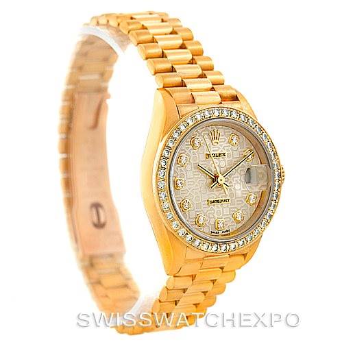 The Rolex President 69138 Women
s Yellow Gold Beige Dial 69138 Women
s Yellow Gold Beige Dial model watch is photographed at an oblique angle showing the face, bezel, and part of the bracelet.