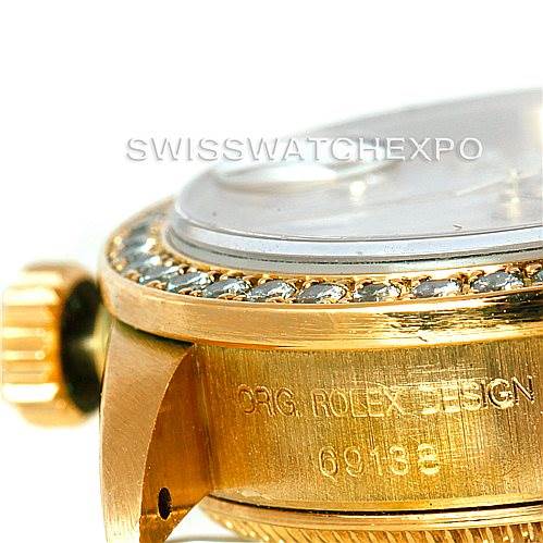 The image shows a close-up side view of the Rolex President 69138 Women
s Yellow Gold Beige Dial 69138 Women
s Yellow Gold Beige Dial watch, highlighting the bezel, crown, and case with model number engraving.