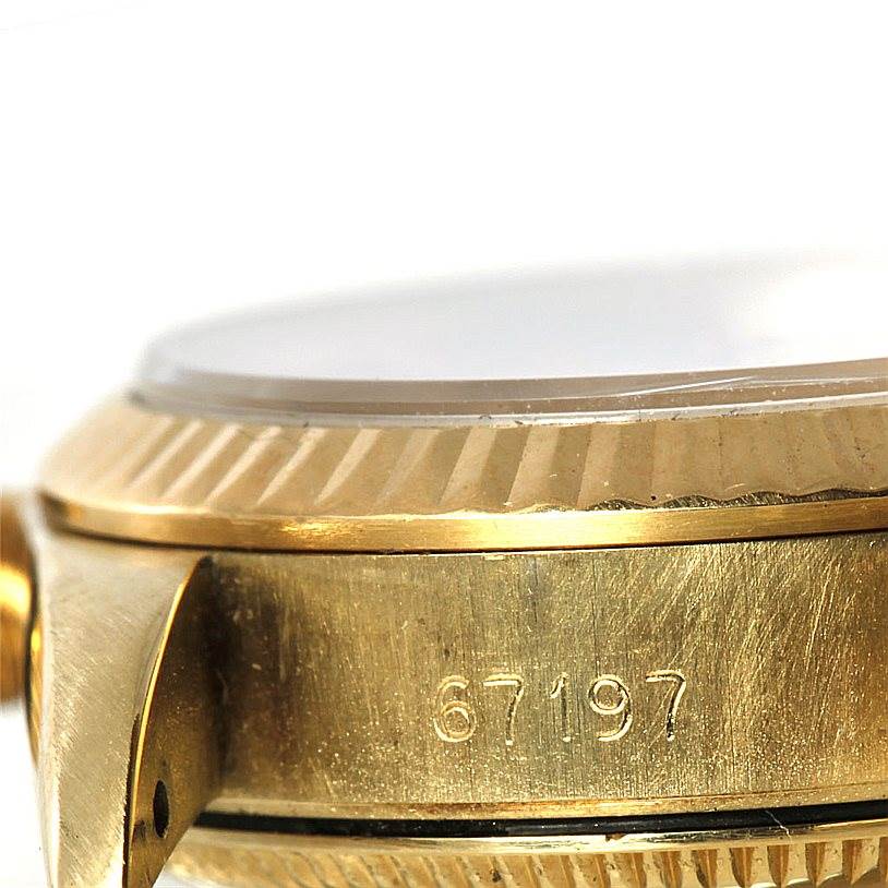 Close-up side view of a Rolex President 67197 Women's Yellow Gold Champagne Dial 67197 Women's Yellow Gold Champagne Dial watch, revealing part of the bezel and case with engraved numbers.