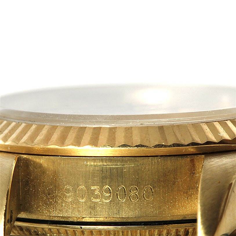 This close-up image of a Rolex President 67197 Women's Yellow Gold Champagne Dial 67197 Women's Yellow Gold Champagne Dial model watch shows the side view, highlighting the fluted bezel and serial number.