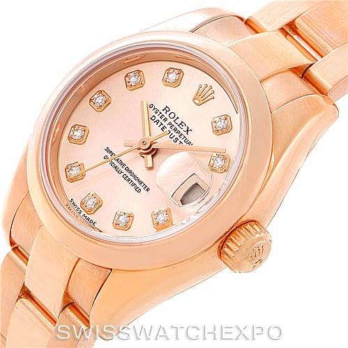 This image shows a close-up angle of the dial, crown, and part of the bracelet of a Rolex President 179165 Women's Rose Gold Pink Dial 179165 Women's Rose Gold Pink Dial model watch.