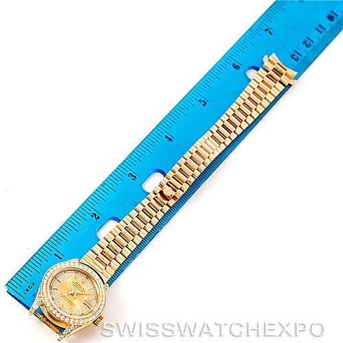 The Rolex President 69158 Women's Yellow Gold Champagne Dial 69158 Women's Yellow Gold Champagne Dial watch is shown from a top-down angle, with a ruler beside it for scale.