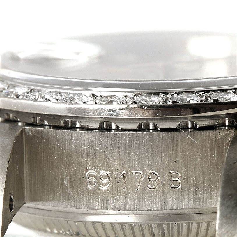 This close-up of the Rolex President 69179B Women's White Gold Brown Dial 69179B Women's White Gold Brown Dial model shows part of the bezel and the engraved model number.