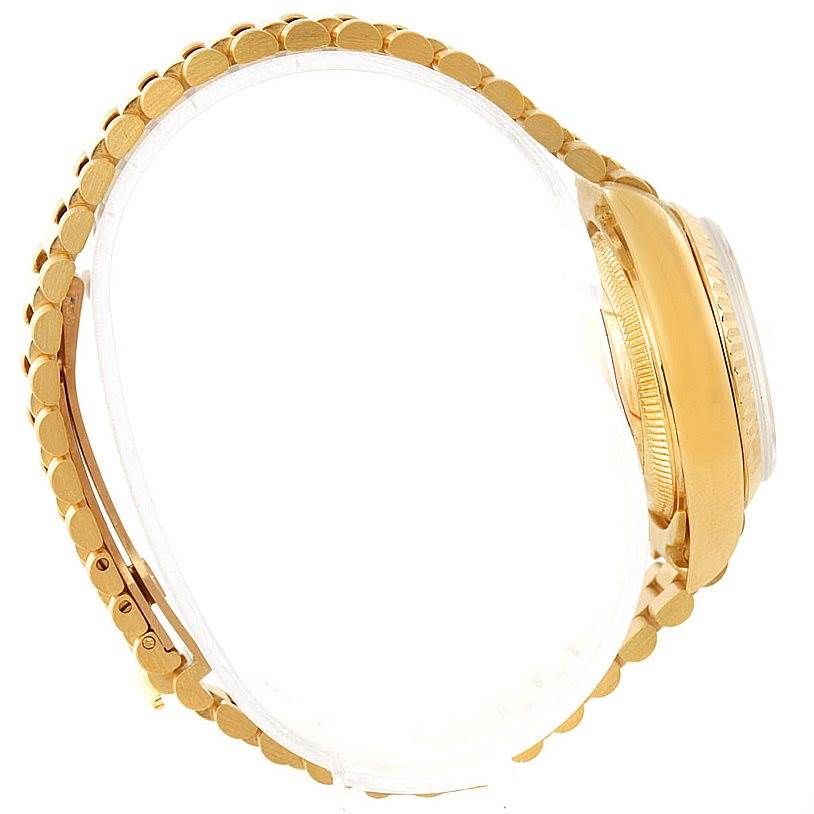 The President model by Rolex is shown from a side angle, highlighting its gold bracelet and case.