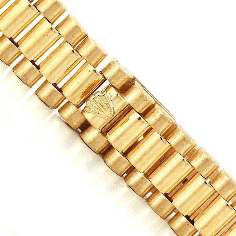 The image shows a close-up view of the gold bracelet of the Rolex President 69178 Women's Yellow Gold Champagne Dial 69178 Women's Yellow Gold Champagne Dial model watch, featuring the Rolex crown logo.