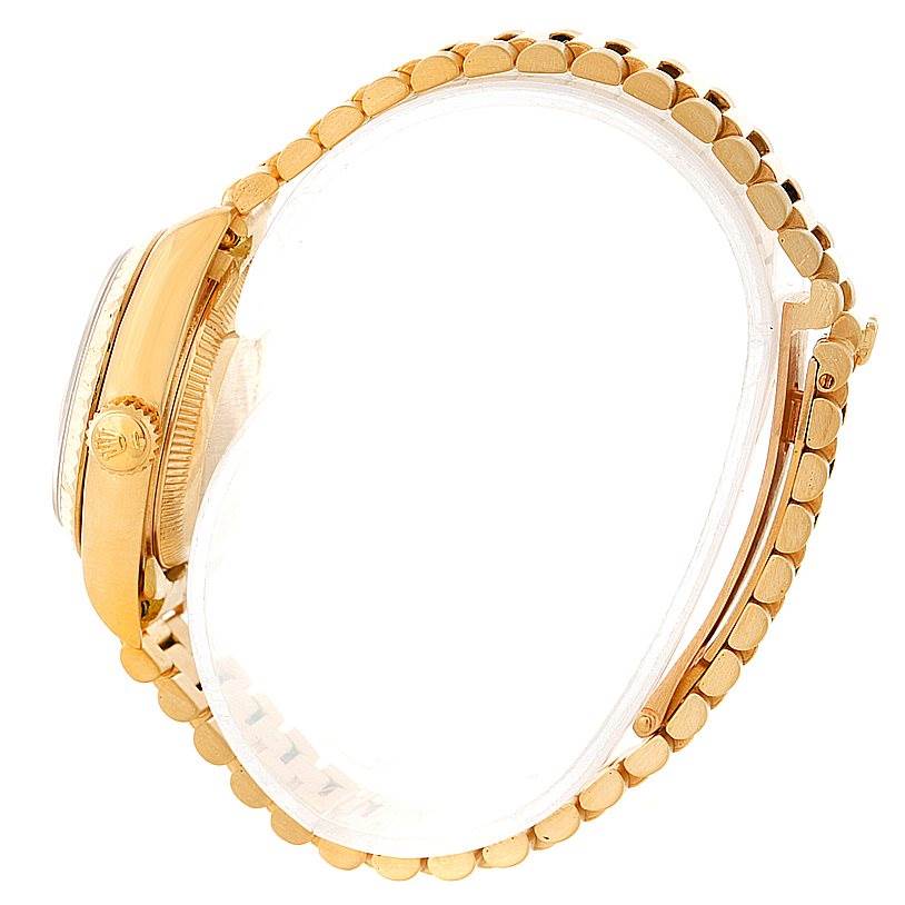 This image shows a side view of a Rolex President 69178 Women's Yellow Gold Champagne Dial 69178 Women's Yellow Gold Champagne Dial model watch, highlighting the crown, case, and part of the bracelet.