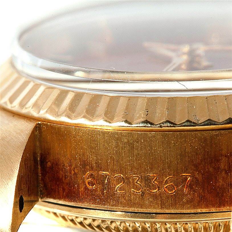 The image shows a close-up of the Rolex President 6917 Women's Yellow Gold Brown Dial 6917 Women's Yellow Gold Brown Dial watch's case, bezel, and crystal from a side angle, highlighting its serial number.