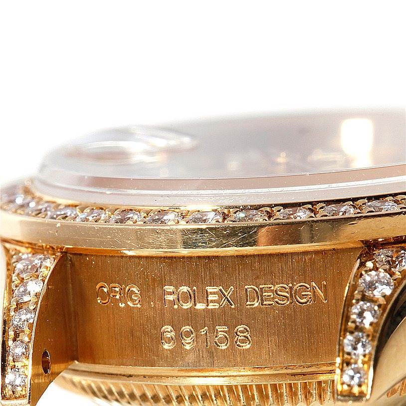 The image shows a close-up of the case side and lugs of a Rolex President 69158 Women's Yellow Gold Champagne Dial 69158 Women's Yellow Gold Champagne Dial watch model, including the bezel and serial number.