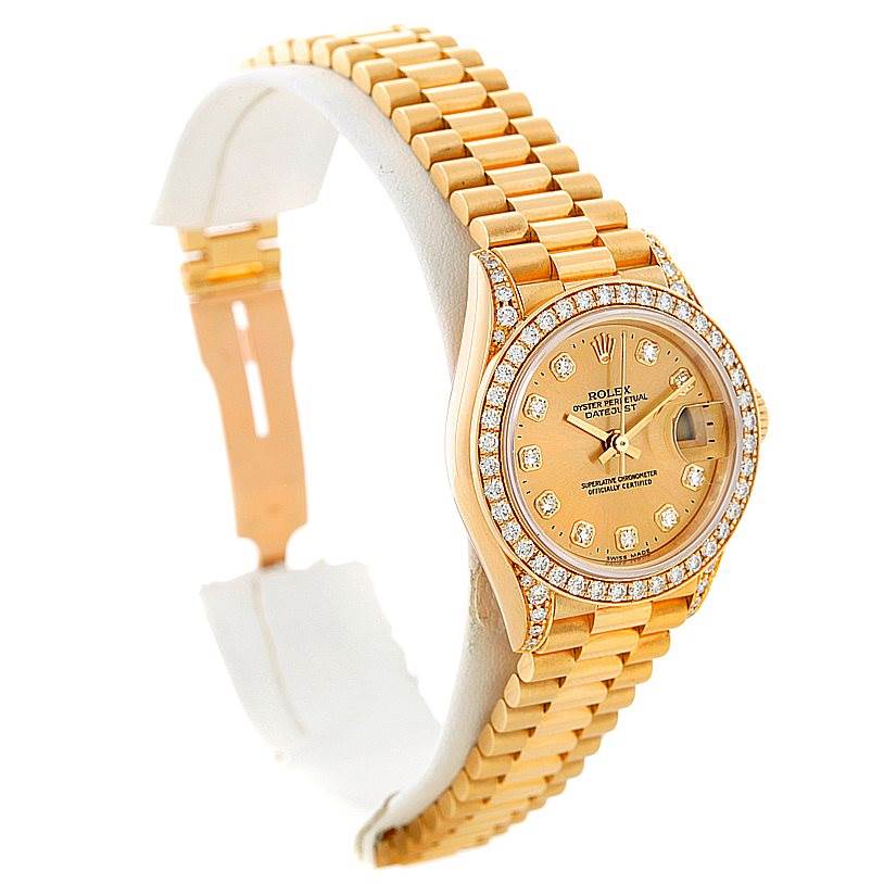 The image shows a side angle view of a Rolex President 69158 Women's Yellow Gold Champagne Dial 69158 Women's Yellow Gold Champagne Dial model watch, featuring its gold bracelet and diamond-encrusted bezel.