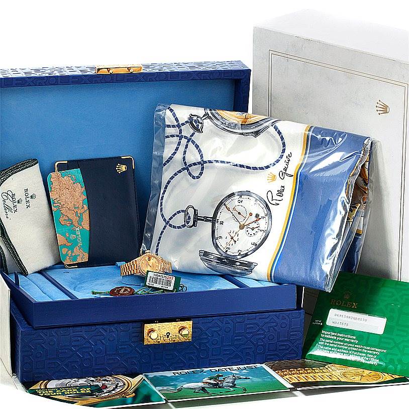 This image shows the Rolex President 69158 Women's Yellow Gold Champagne Dial 69158 Women's Yellow Gold Champagne Dial watch along with its accessories, boxes, and paperwork displayed at an angle from above.