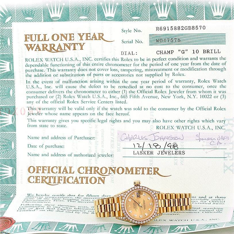 The image shows a top view of a Rolex President 69158 Women's Yellow Gold Champagne Dial 69158 Women's Yellow Gold Champagne Dial model watch in front of its warranty and certification documents.