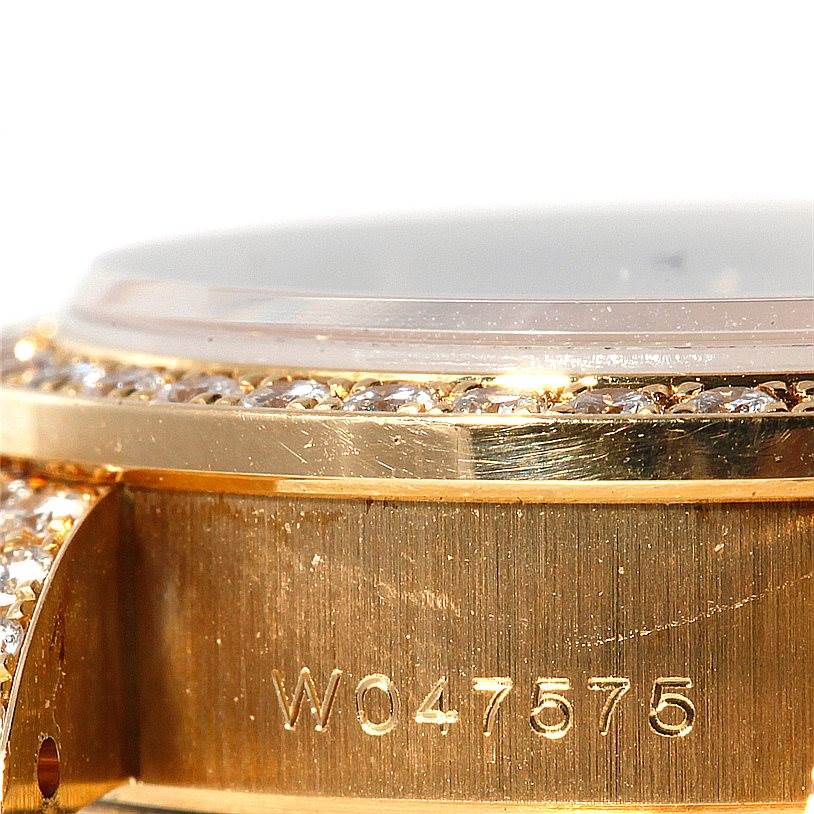 This close-up image shows the side view of a Rolex President 69158 Women's Yellow Gold Champagne Dial 69158 Women's Yellow Gold Champagne Dial model watch with part of the bezel and serial number visible.