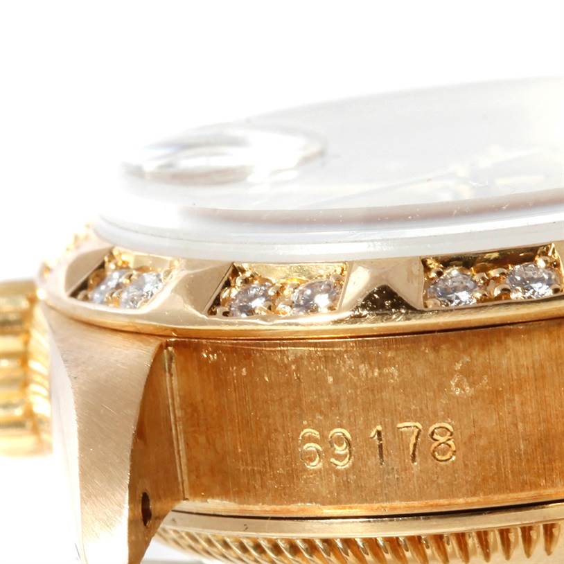 This close-up image of a Rolex President 69178 Women's Yellow Gold Champagne Dial 69178 Women's Yellow Gold Champagne Dial model watch shows part of the case, diamond-encrusted bezel, and model number 69178.