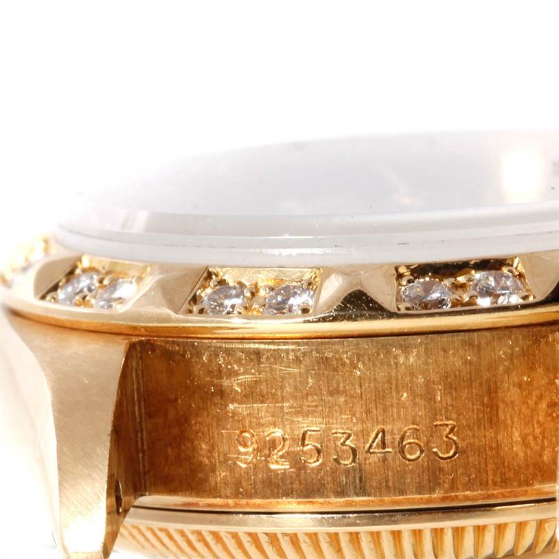 The image shows a close-up of the side of the bezel and case, with diamonds and serial number, of a Rolex President 69178 Women's Yellow Gold Champagne Dial 69178 Women's Yellow Gold Champagne Dial model watch.