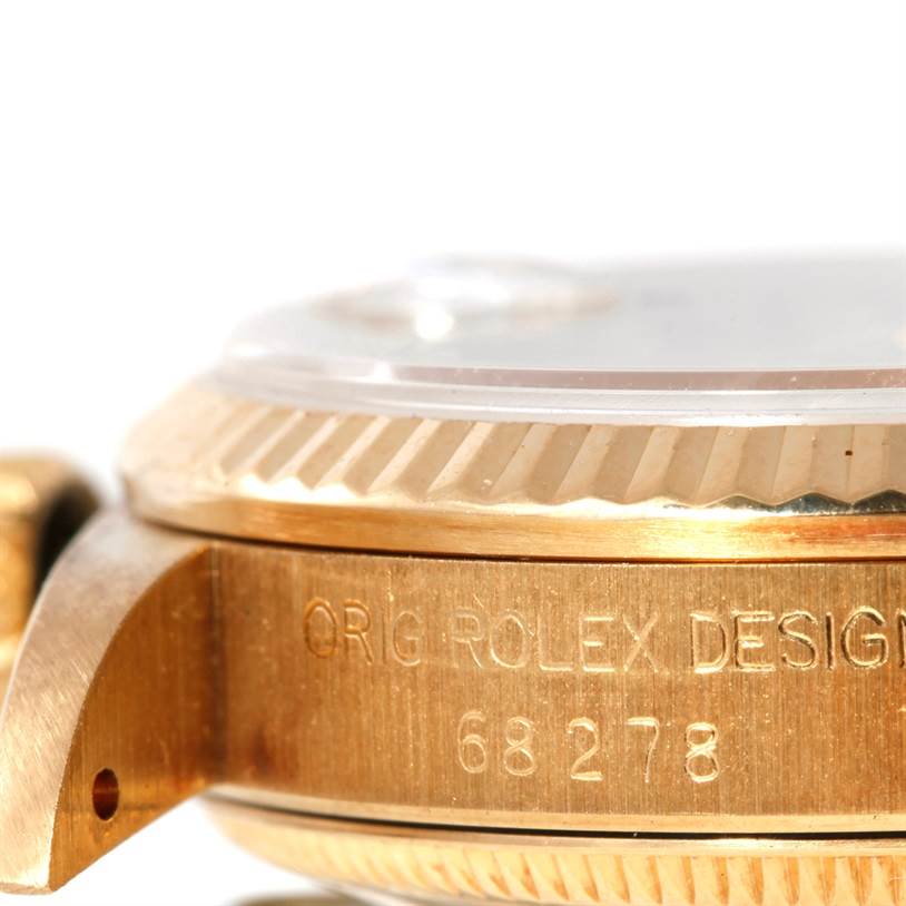 The image shows a close-up of the side engraving and bezel of a Rolex President 68278 Women's Yellow Gold Champagne Dial 68278 Women's Yellow Gold Champagne Dial model watch.