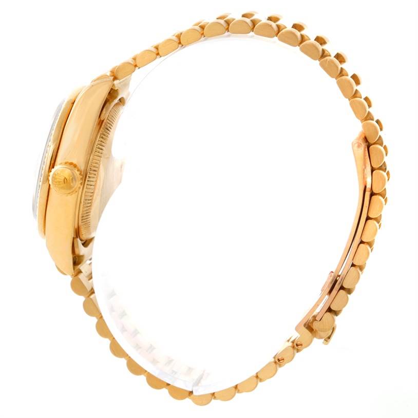 This side view of the Rolex President 69178 Women's Yellow Gold White Dial 69178 Women's Yellow Gold White Dial model showcases the crown, case, and part of the bracelet.