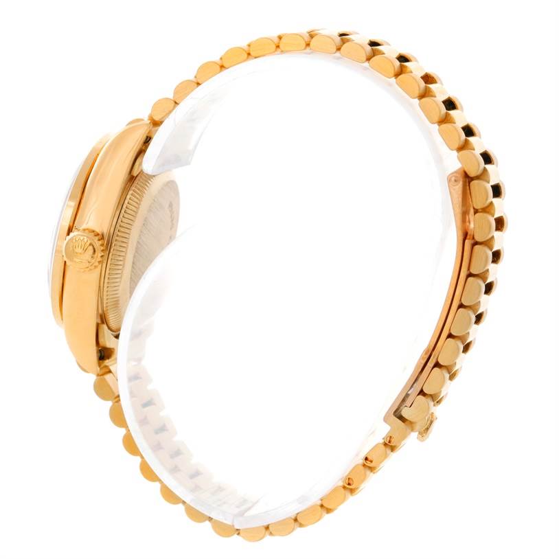 The image shows a side view of a Rolex President 69178 Women's Yellow Gold Mother of Pearl Dial 69178 Women's Yellow Gold Mother of Pearl Dial model watch, highlighting its gold case, crown, and bracelet.