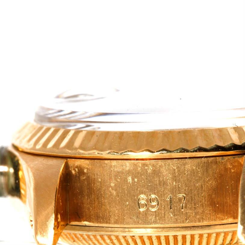 The image shows a close-up side view of a Rolex President 6917 Women's Yellow Gold Champagne Dial 6917 Women's Yellow Gold Champagne Dial model watch, focusing on the bezel and case with the model number 6917.