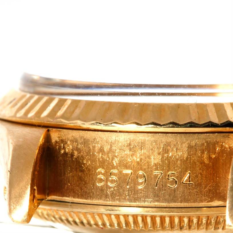 This is a close-up of the case side and bezel of a Rolex President 6917 Women's Yellow Gold Champagne Dial 6917 Women's Yellow Gold Champagne Dial model watch, showing its serial number.