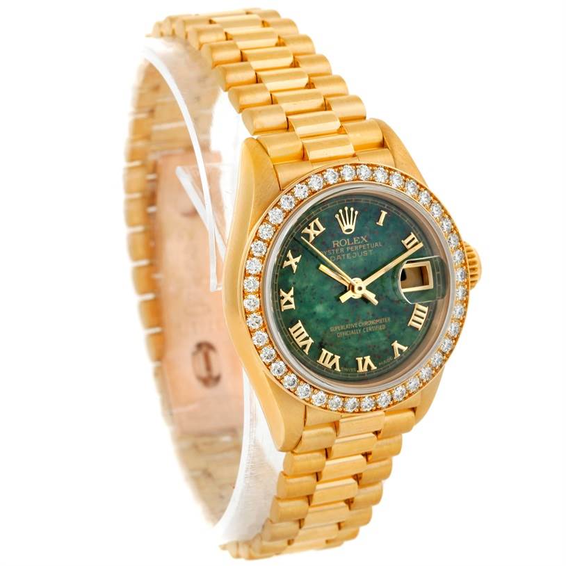 This image showcases a Rolex President 69178 Women's Yellow Gold Green Dial 69178 Women's Yellow Gold Green Dial model watch at an angle highlighting the gold band, green dial, and diamond-encrusted bezel.
