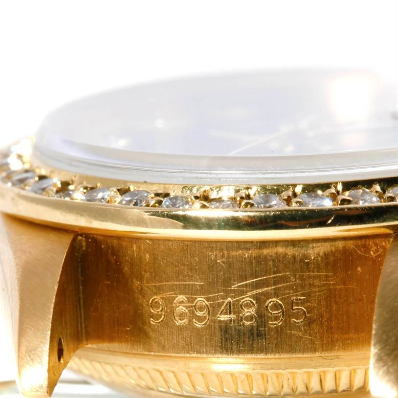 This image shows a close-up, angled view of the Rolex President 69178 Women's Yellow Gold Green Dial 69178 Women's Yellow Gold Green Dial model watch, highlighting its serial number, bezel with diamonds, and part of the case.