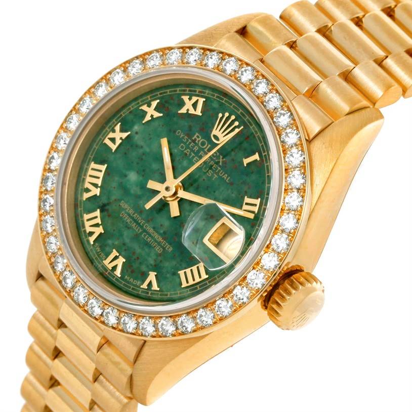 This image shows the face, crown, and bracelet of the Rolex President 69178 Women's Yellow Gold Green Dial 69178 Women's Yellow Gold Green Dial model watch at a slight angle.