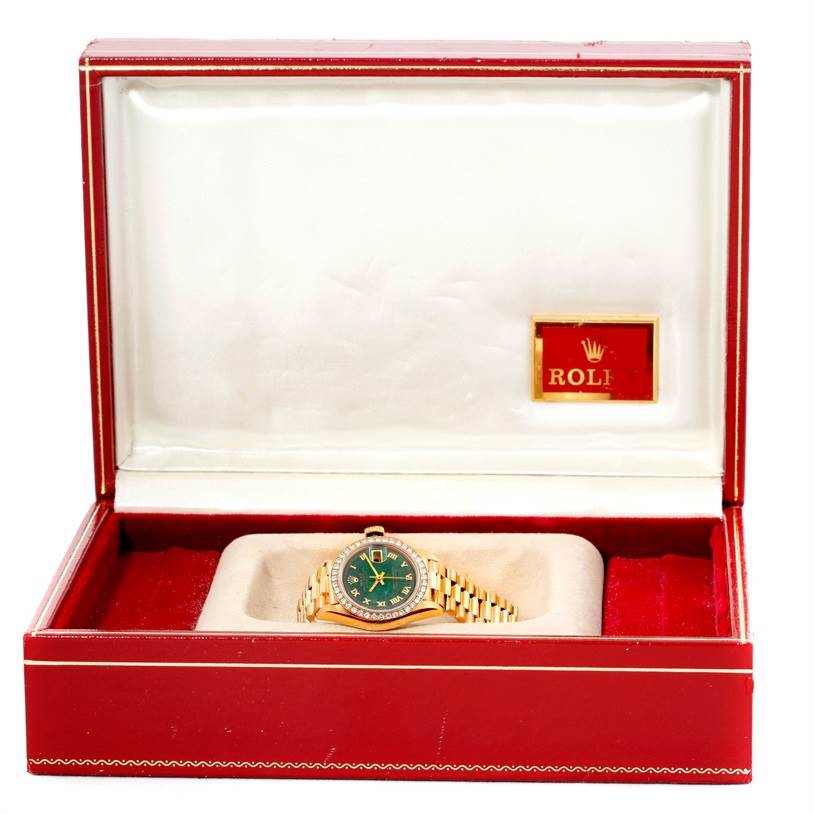 The Rolex President 69178 Women's Yellow Gold Green Dial 69178 Women's Yellow Gold Green Dial model watch is shown inside its open red and white box.