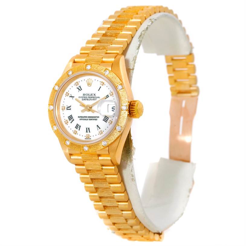 The image shows a Rolex President 69288 Women's Yellow Gold White Dial 69288 Women's Yellow Gold White Dial watch at an angled side view, showcasing the gold bracelet, case, crown, and dial with diamond accents.