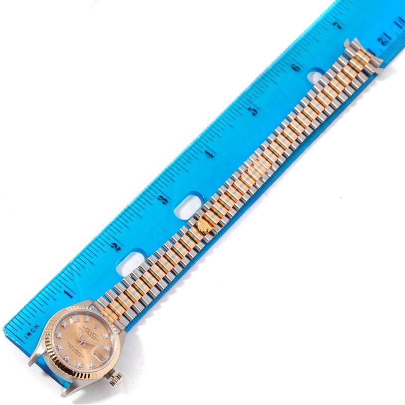 The Rolex President 69179B Women's White Gold Brown Dial 69179B Women's White Gold Brown Dial model watch is shown with a blue ruler, displaying the face, bezel, and full bracelet length.