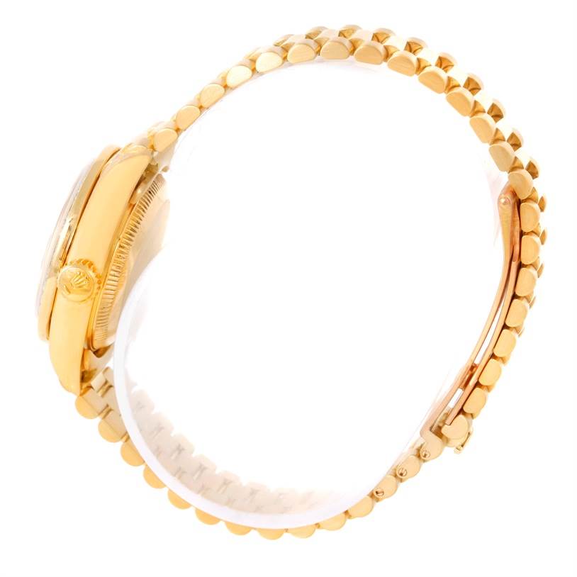 The image shows a side profile of a gold Rolex President 69178 Women's Yellow Gold Champagne Dial 69178 Women's Yellow Gold Champagne Dial model watch, focusing on its crown and bracelet.