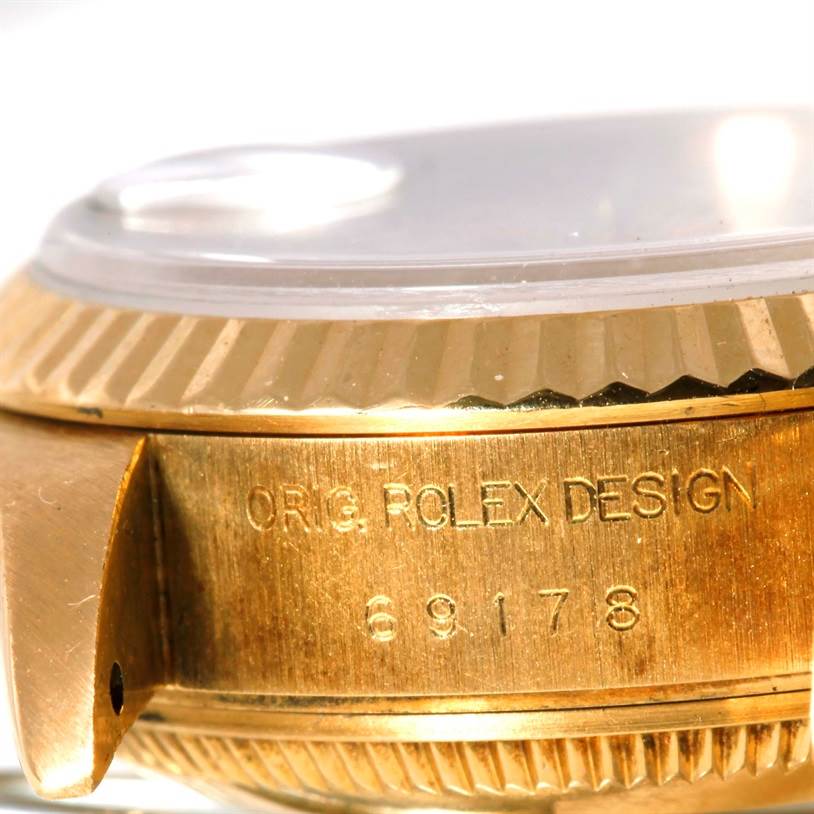 This close-up image shows the side of a Rolex President 69178 Women
s Yellow Gold Beige Dial 69178 Women
s Yellow Gold Beige Dial model watch, highlighting the engraved design and model number.