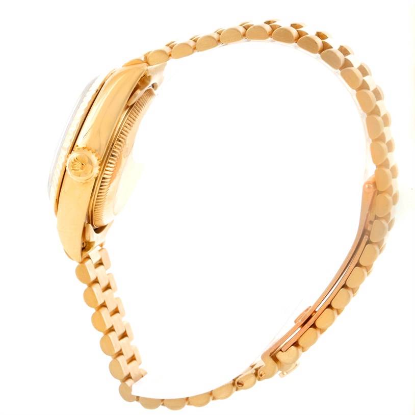 This image shows a Rolex President 69178 Women
s Yellow Gold Beige Dial 69178 Women
s Yellow Gold Beige Dial model watch from a side angle, highlighting the crown, case, and bracelet.