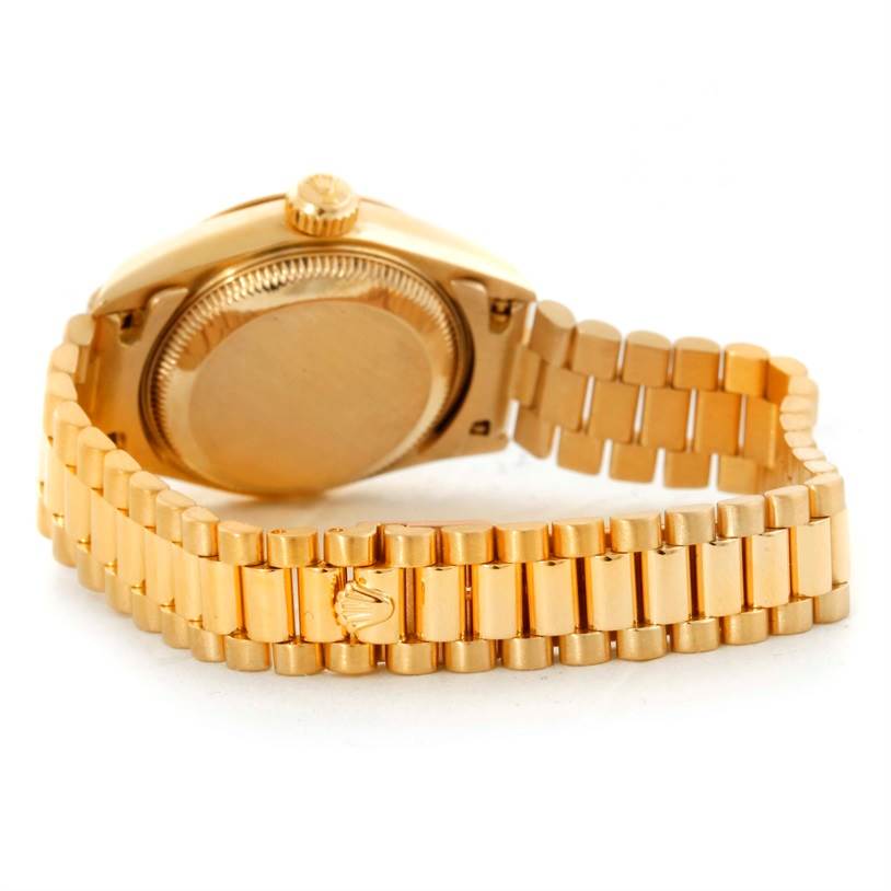 The image shows the back case and part of the bracelet of a Rolex President 69178 Women
s Yellow Gold Beige Dial 69178 Women
s Yellow Gold Beige Dial model watch from a rear angle.